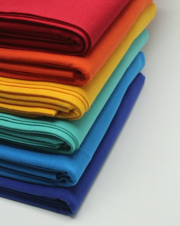 Stack of folded cotton fabrics in bright colours